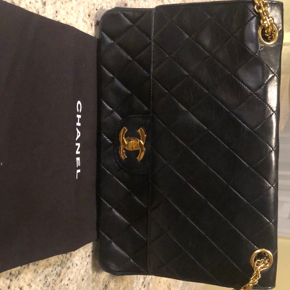 CHANEL Vintage double flap bag quilted lamb skin with gold hardware.